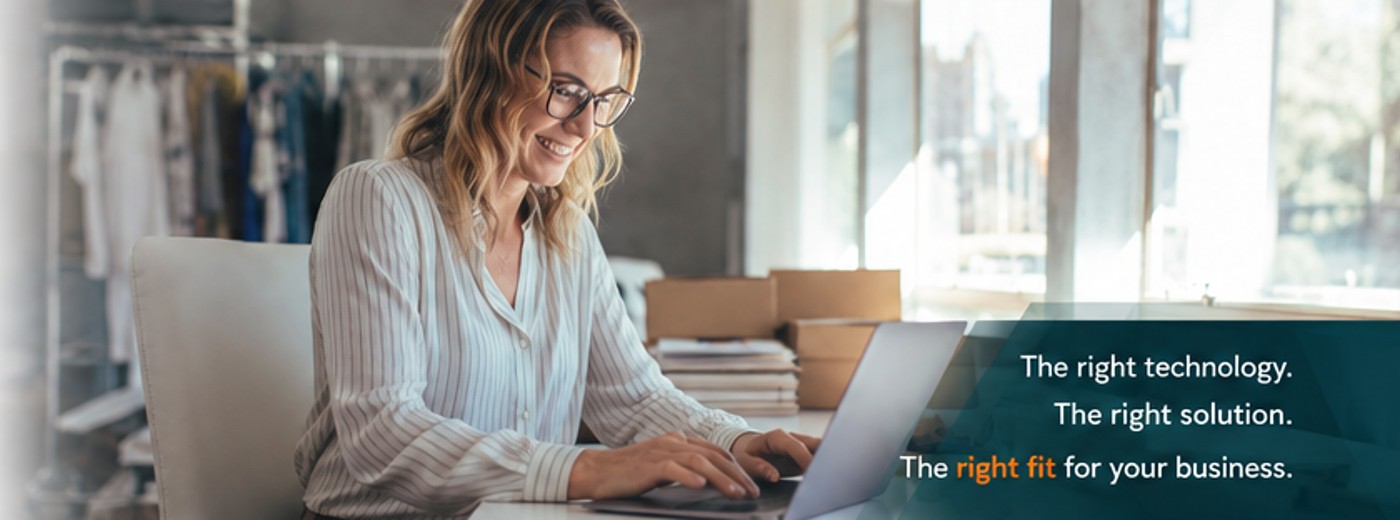 Small business owner working with technology at a laptop